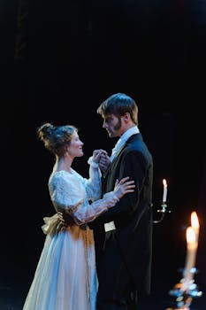 A romantic theater scene with a couple performing in elegant costumes by candlelight.