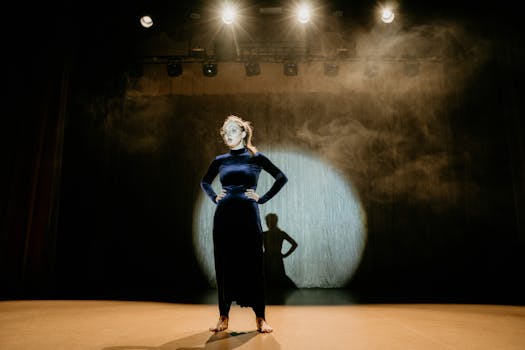 Captivating shot of a performer in a velvet dress on stage under dramatic lighting.